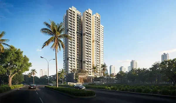 Tall residential tower beside a landscaped road, showing the urban edge of North Bangalore